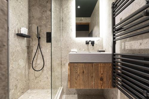 a bathroom with a sink and a shower at Hotel Le Chabichou in Courchevel