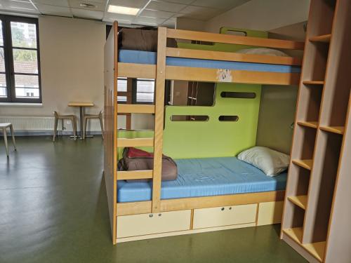 a room with bunk beds and a table at Auberge de Jeunesse HI Rouen in Rouen