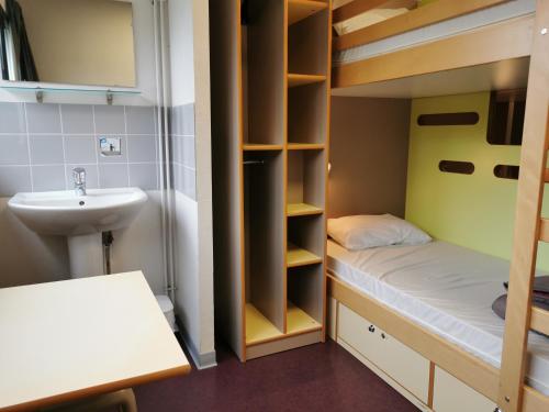 a small bathroom with a bunk bed and a sink at Auberge de Jeunesse HI Rouen in Rouen