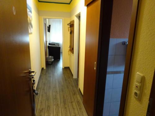 a hallway leading to a bathroom with a toilet at Miramar in Dahme