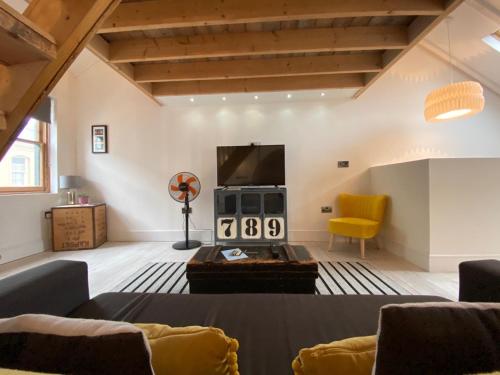 a living room with a couch and a television at The Antidote in Ilfracombe