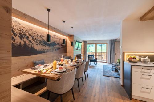 a dining room with a long table and chairs at Brunnenhof Luxury Apartments in Lech am Arlberg