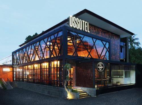 a building with a sign on the front of it at Ossotel Legian in Legian