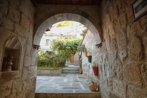 an archway in a stone wall with an alley at Traveller's Cave Hotel in Goreme