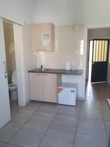 a kitchen with a sink and a counter top at Sea CleoNapa Mandali in Ayia Napa
