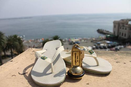 a pair of white sandals sitting on top of a building at Hotel Mediterranee in Genova