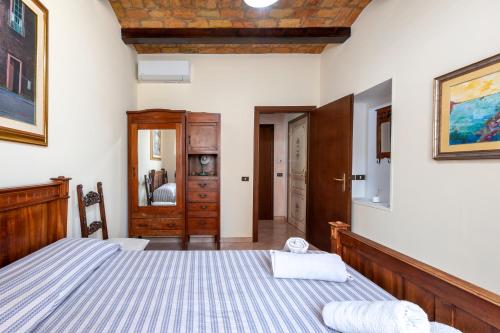 a bedroom with a bed and a wooden headboard at Kyterion Apartment in Rome