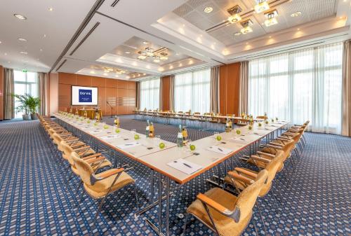 a large conference room with a long table and chairs at Dorint Am Nürburgring Hocheifel in Nürburg