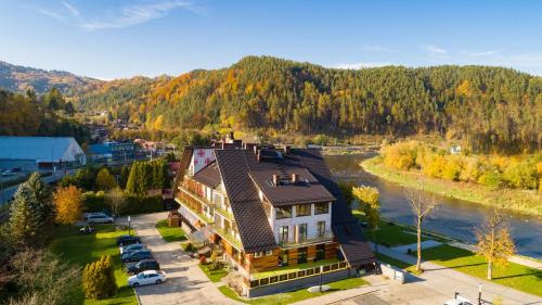 an aerial view of a large house next to a river at Hotel Piwniczna SPA&Conference in Piwniczna