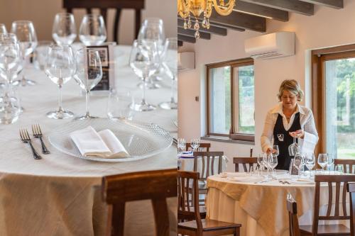 a woman standing in front of a table with wine glasses at Agriturismo Buonasera in Bagnoregio