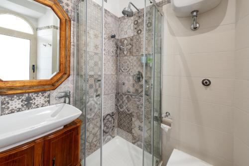a bathroom with a shower and a sink and a mirror at Kyterion Apartment in Rome
