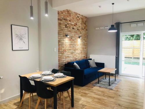 a living room with a table and a blue couch at Property Apart - Soft Lofty Legnicka Centrum in Wrocław