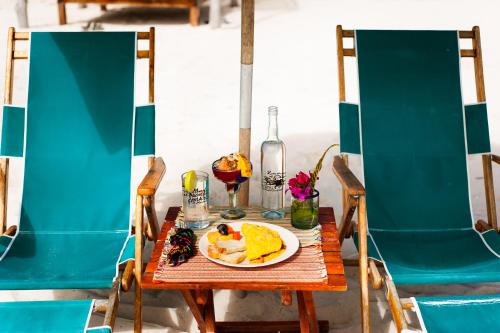 a table with a plate of food on it at Nacional Beach Club & Bungalows in Mahahual