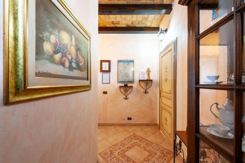 a hallway with a painting on the wall and a picture on the wall at Kyterion Apartment in Rome