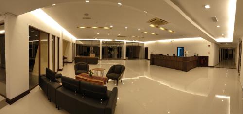 a lobby with chairs and a table in a building at TEMU PRIMULA in Kampong Seberang Timor