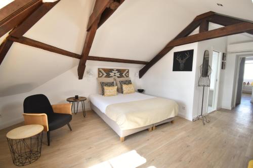 a room with a bed, chair, and table in it at Sophia Residences in Coimbra