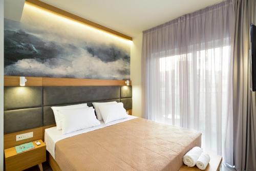 Ένα ή περισσότερα κρεβάτια σε δωμάτιο στο Elia Kalamaki Hotel