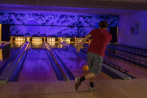 a man playing bowling in a bowling alley at Eaglewood Resort & Spa in Itasca