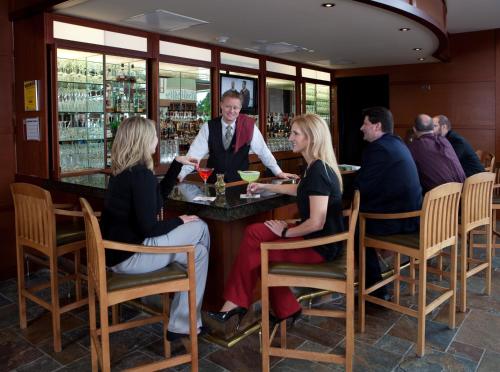 a group of people sitting at a bar in a restaurant at Eaglewood Resort & Spa in Itasca