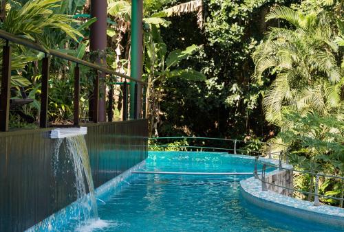 a swimming pool with a waterfall in a resort at Paraíso Azul Retiro in Abraão