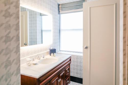 a bathroom with a sink and a mirror at Dunhill Hotel in Charlotte