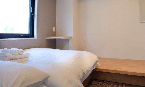 a hotel room with a bed and a window at The Light Inn - Vacation STAY 94706 in Tokyo