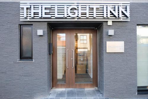 a entrance to a building with a wooden door at The Light Inn - Vacation STAY 94706 in Tokyo