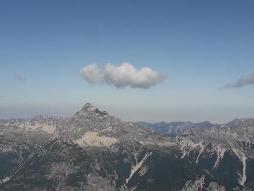 a view of a mountain range with a blue sky at Apart Lechtraum in Stanzach