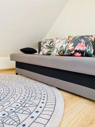 a bedroom with a bed with a rug on the floor at Apartament Limonka in Wierzchucino