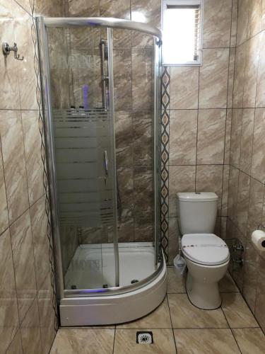 a bathroom with a shower with a toilet and a shower at Liman Hotel in Istanbul