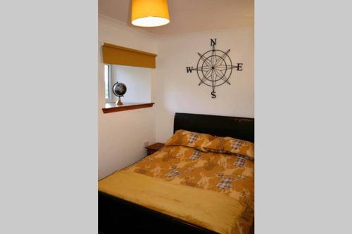 a bedroom with a bed with a wheel on the wall at Little Red Kirriemuir in Kirriemuir