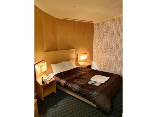 a hotel room with a bed and two night stands at Hotel Grand Vert Gizan - Vacation STAY 95366 in Gifu
