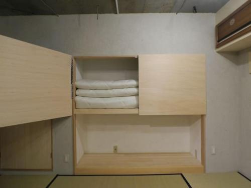 Zimmer mit einem Schrank mit einigen Handtüchern in der Unterkunft New Art Building - Vacation STAY 95699 in Tokio