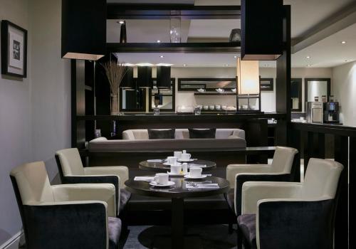 a dining room with a table and a couch at Crowne Plaza - Belfast by IHG in Belfast