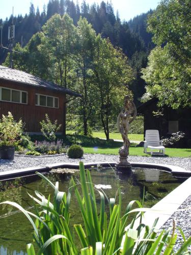 a fountain in the middle of a garden at Haus Telisia in Klösterle am Arlberg