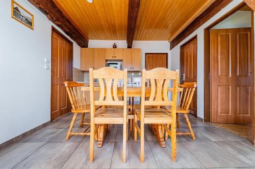 a dining room with a table and chairs at Family apartments V Zátiší in Dolní Morava