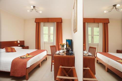 Postel nebo postele na pokoji v ubytování Hotel Michelangelo