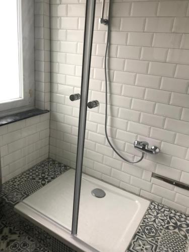 a shower with a glass door in a bathroom at TM Aparts in Dortmund
