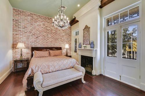 a bedroom with a bed and a window at French Quarter 3 Bedroom Condo with Balcony in New Orleans