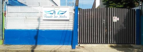 
a blue and white fence next to a blue door at Posada San Nicolas in San Andrés
