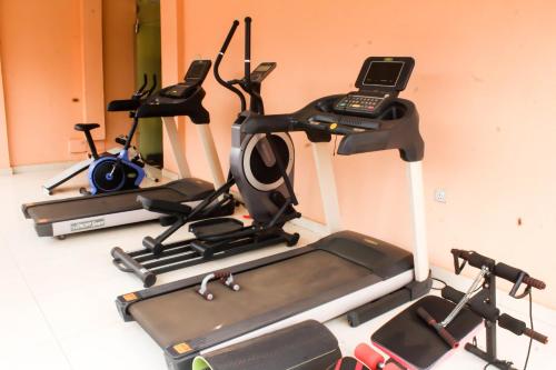 a group of three exercise bikes and a phone on a treadmill at SWEET PEE EXECUTIVE HOTEL in Ayeduasi