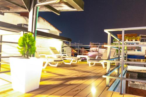 a deck with chairs and a potted plant on a boat at Casa Amanzi Cartagena by Bernalo Hotels in Cartagena de Indias