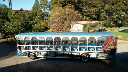 a toy bus with animals painted on the side of it at Pousada São Chico Eco Village in São Francisco de Paula