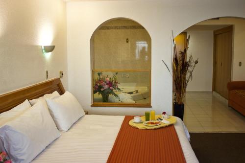 Postel nebo postele na pokoji v ubytování San Juan Park Hotel