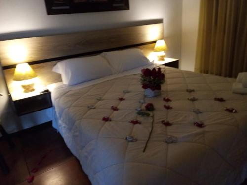 a bedroom with a large bed with flowers on it at Pousada São Chico Eco Village in São Francisco de Paula