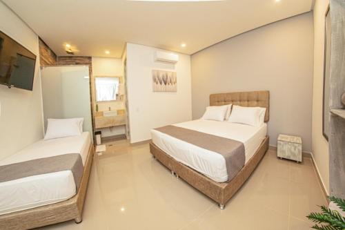a bedroom with two beds in a room at Casa Amanzi Cartagena by Bernalo Hotels in Cartagena de Indias