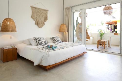 a bedroom with a large bed and a balcony at El 55 Sayulita Stylish couple getaway rooftop pool in Sayulita
