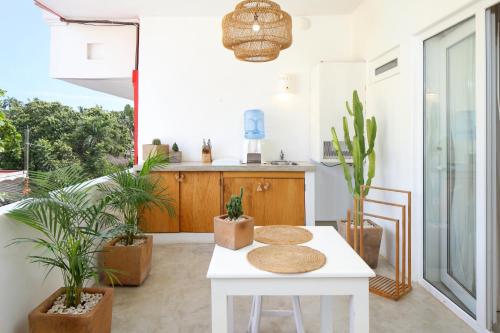 a white table in a room with plants at El 55 Sayulita Stylish couple getaway rooftop pool in Sayulita