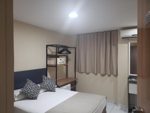 a hotel room with a bed and a window at Villa Park Hotel Fortaleza in Fortaleza