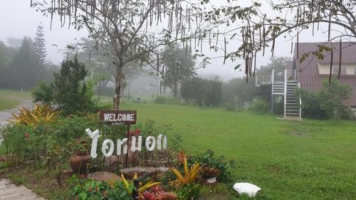 a yard with a sign that reads the home reunion at ไอหมอก ชาเล่ต์ in Wang Nam Khieo